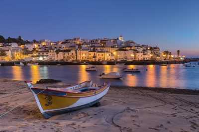 View of Ferragudo village at night from sand flats