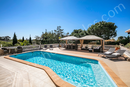 view across terrace and pool towards dexterior dining and sea in the distance