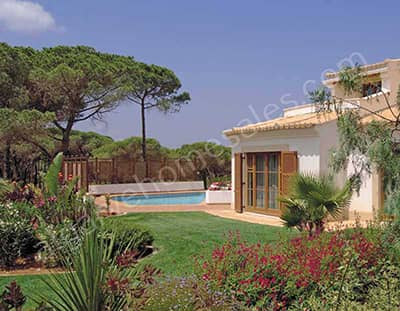 Looking across the garden and the corner of the house to a pool