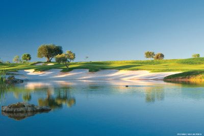 Golf course with white sand by teh edge of a lake