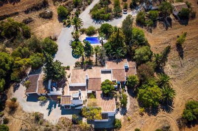 Aerial view of property with pool and outbuildings
