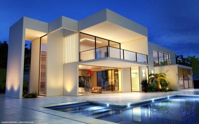 Villa with lights on, pool and surrounding terrace