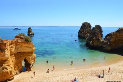 View of beach with people enjoying the sea