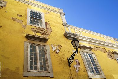 Old yellow building in need of renovation with blue sky