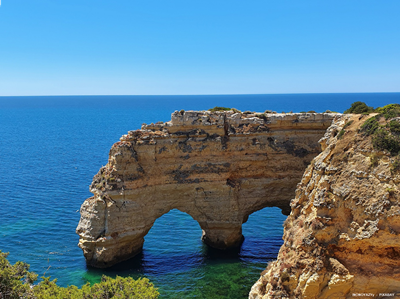Cliff view of two sea arches off the coast of Algarve