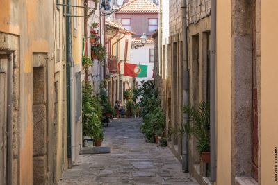 View down a cobbled street lined with terraced houses