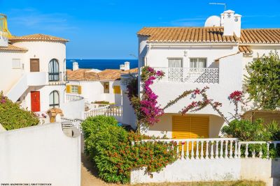 View through properties and gardens to the sea