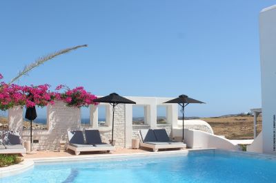 Pool around swimming pool with view throught the wall to the coast