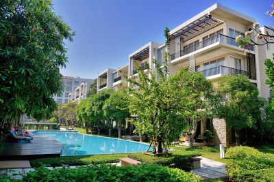 pool with loungers and garden below apartments