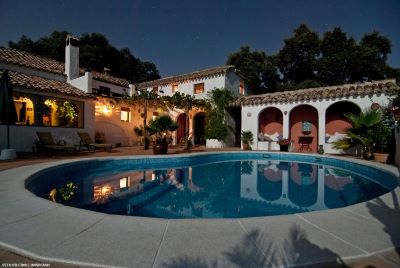 Country villa at dusk with pool and terraces